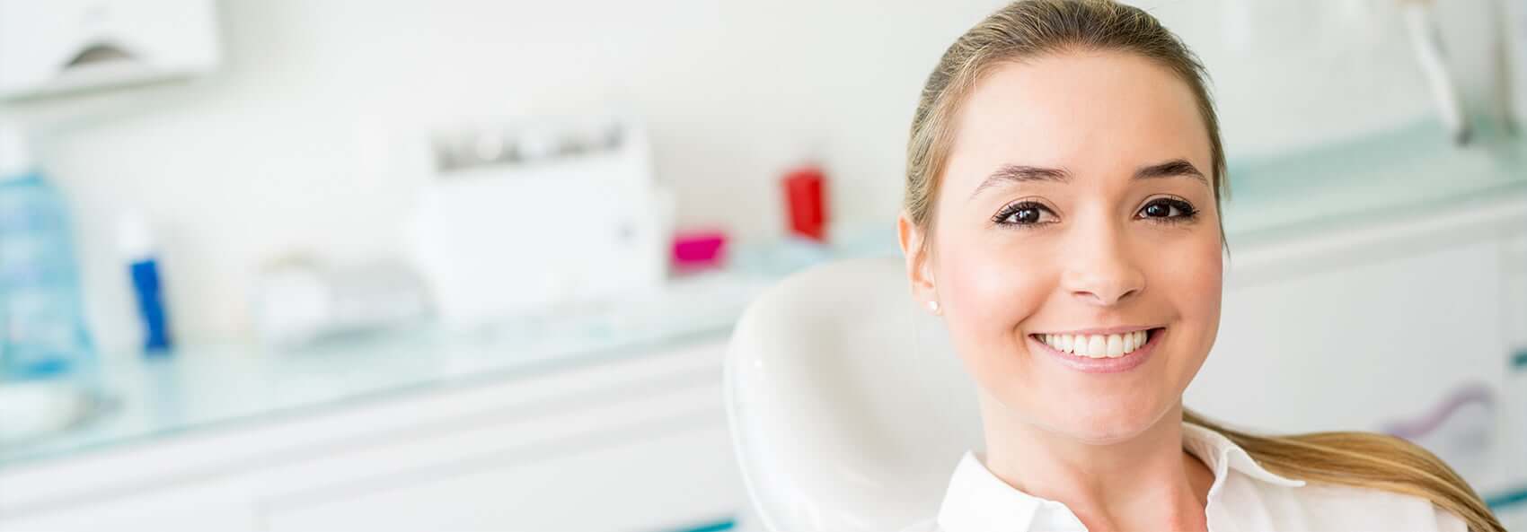 woman smiling sitting in dental exam chair