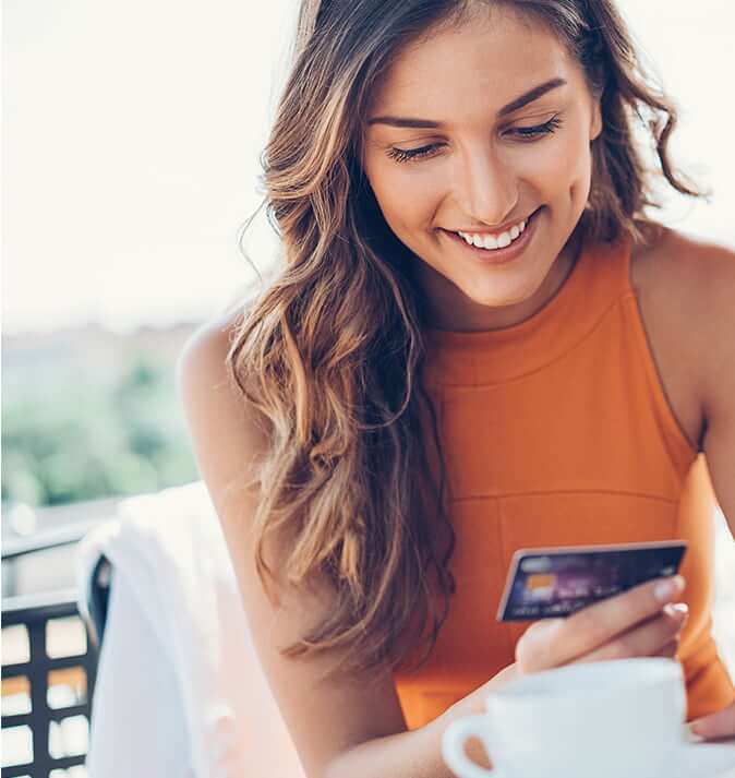 woman smiling at credit card