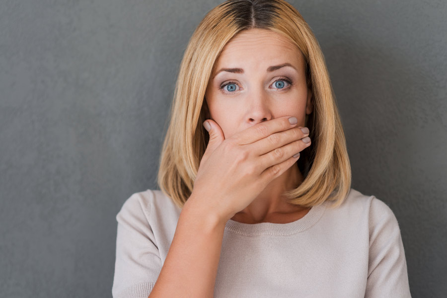 Photo of a woman covering her mouth with her hand. at dentist in hermitage