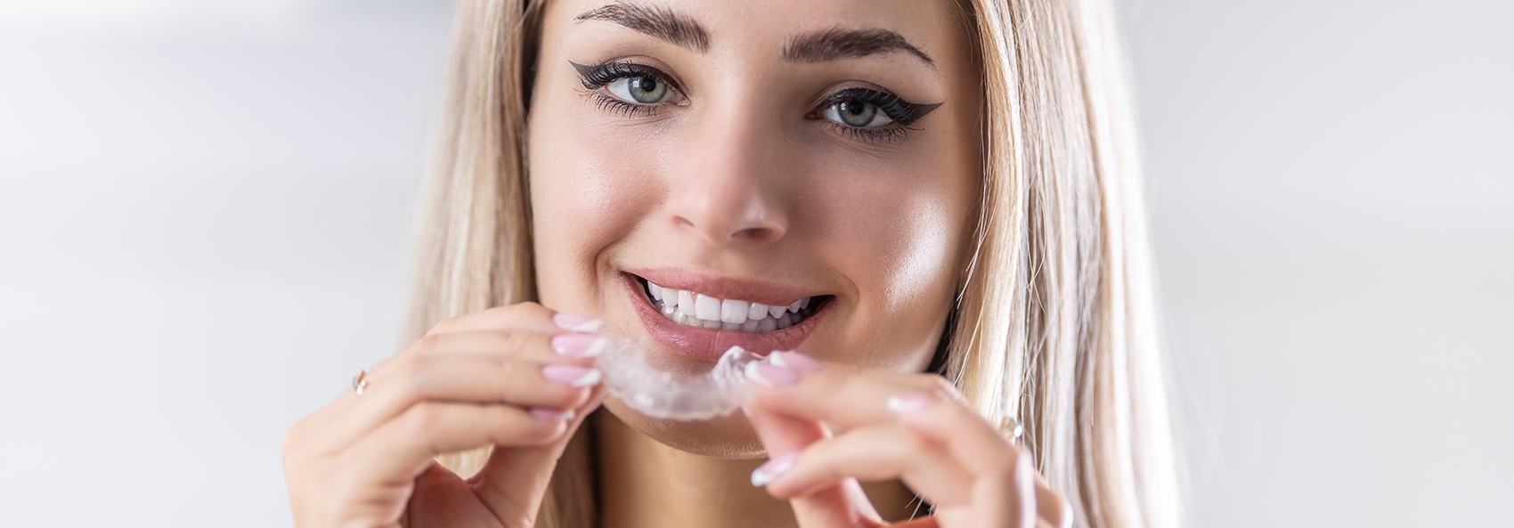 woman smiling with a clear aligner