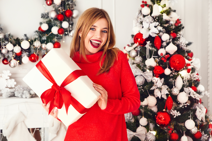 smile makeover, holidays, cosmetic dentistry, woman holding present
