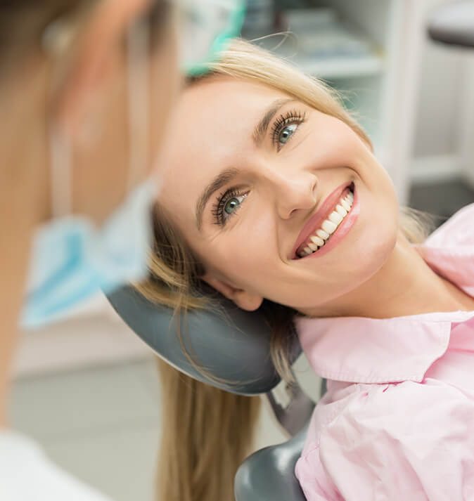 smiling woman sitting in a dental chair