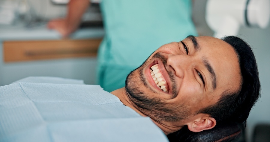 man at dentist for dental cleaning and exam