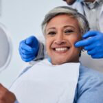 Woman smiling after cosmetic dental treatment