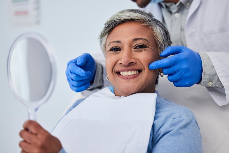 Woman smiling after cosmetic dental treatment
